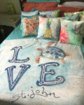 This fleece blanket features sea turtle watercolors. Perfect snuggling up with a book, watching a favorite movie or planning your next vacation on St. John!