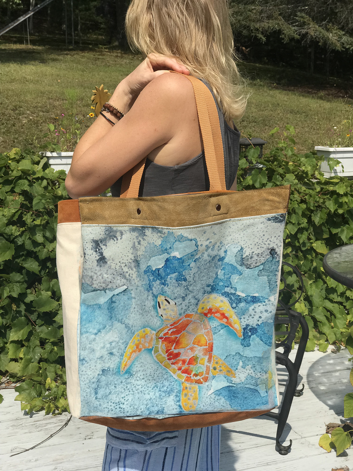 This handmade tote bag features a whimsical green sea turtle swimming through the tranquil Caribbean Sea.