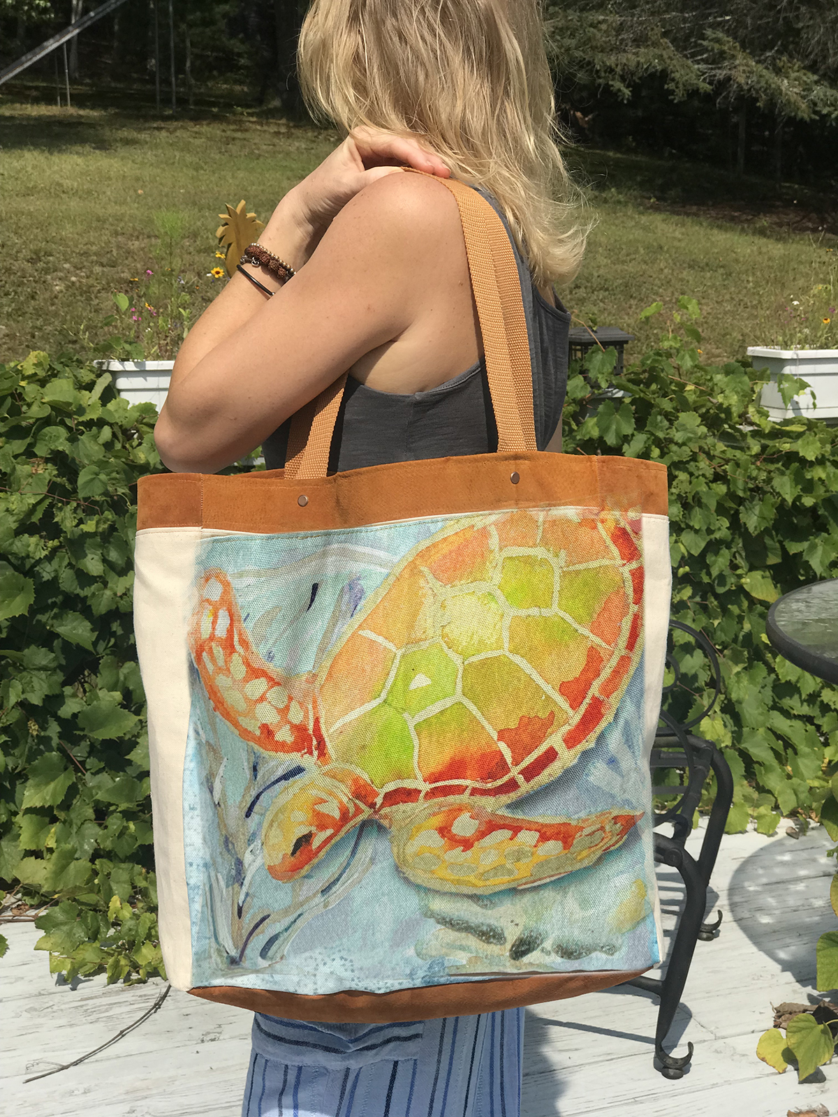 This sea turtle watercolor leather & canvas tote will hold everything you need for the beach and more! It features a whimsical sea turtle swimming through a coral reef. 
